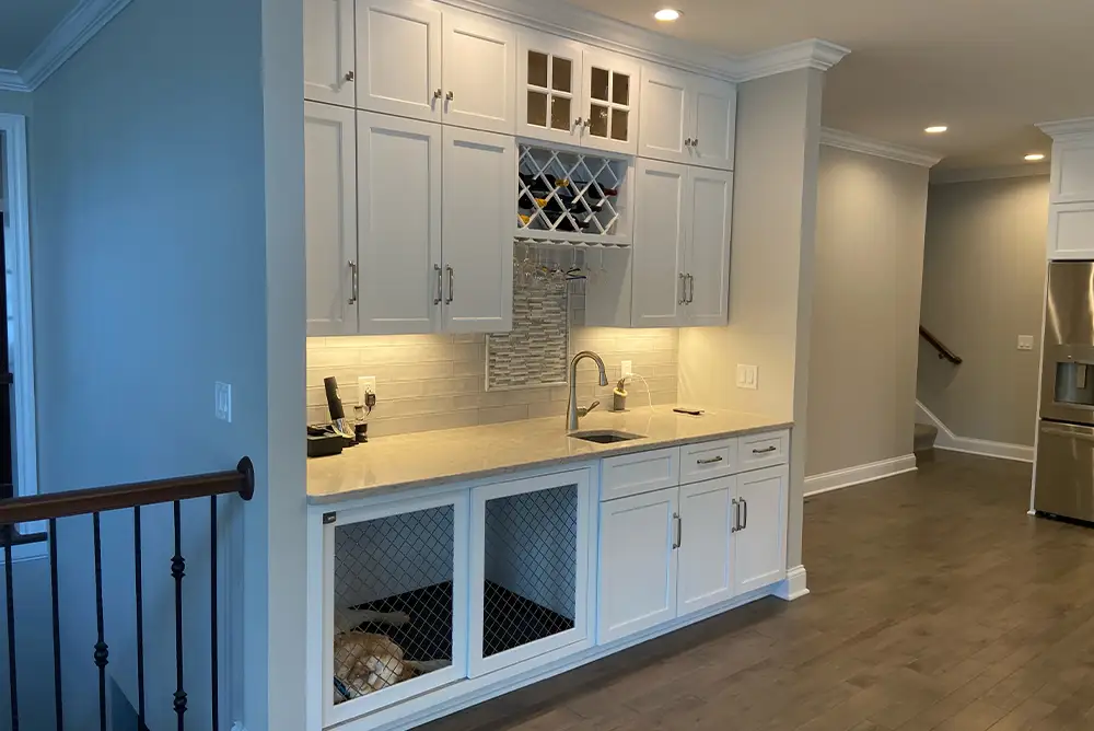 white kitchen cabinets with built in dog crate