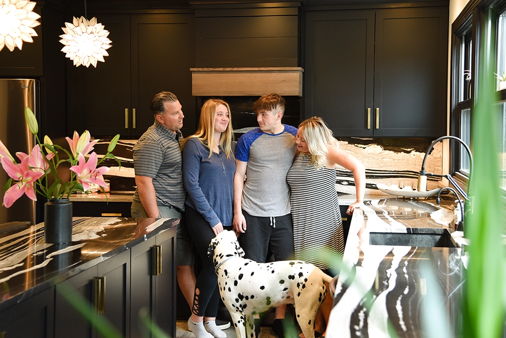 family in their modern black and white kitchen